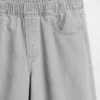 Dziecięce jeansy typu baggy z niskim stanem, kokardką i rozcięciem na dole nogawki