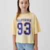 Dziecięcy T-shirt oversize o prostym kroju z logo stanu